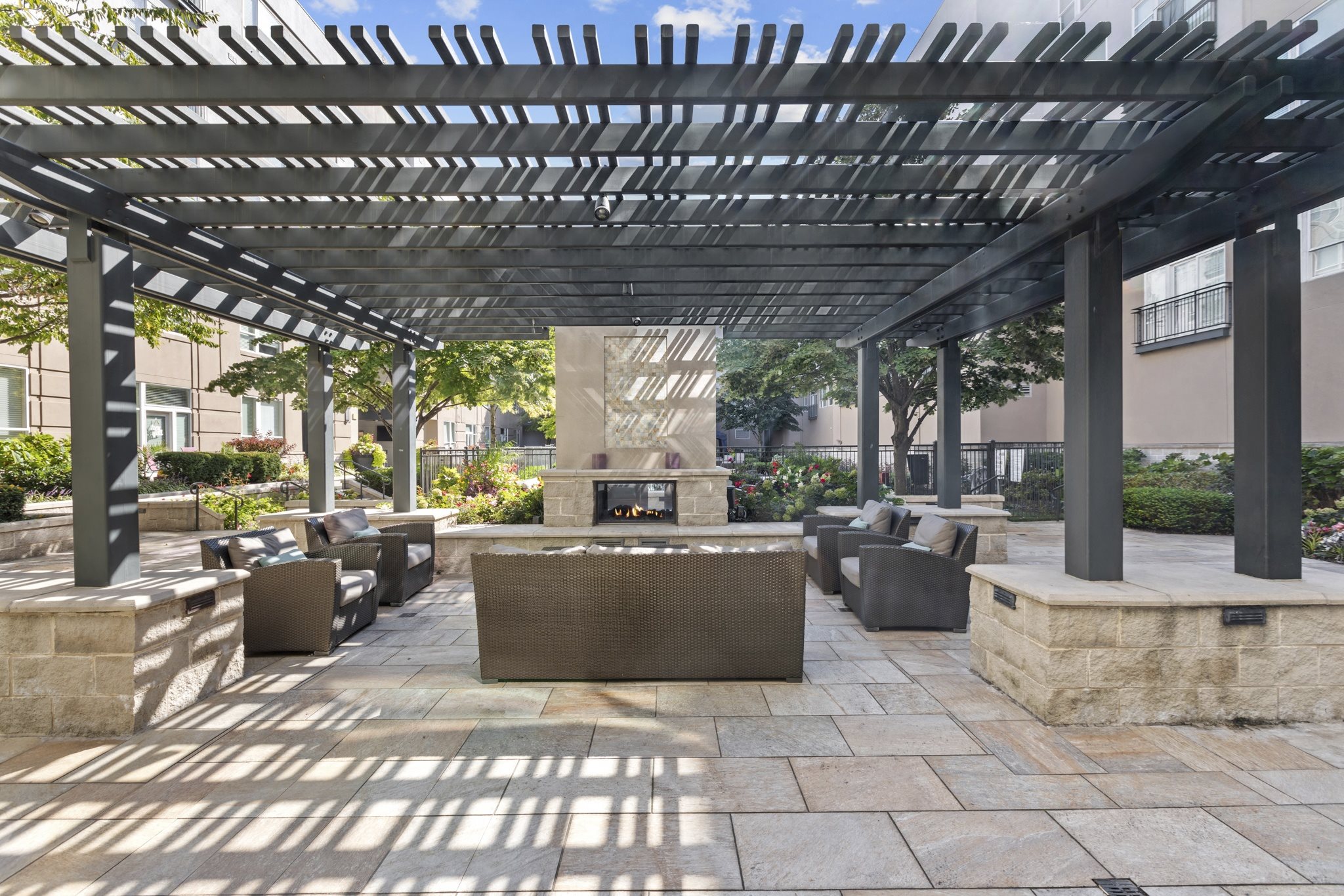 a large patio with tables and chairs and a fireplace
